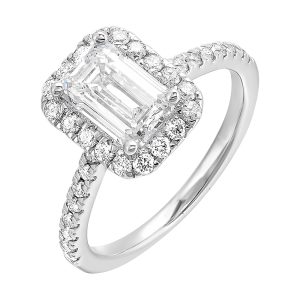 A beautiful emerald cut solitaire set with halo of round diamonds and a diamond studded shank makes this perfect choice of your love story.